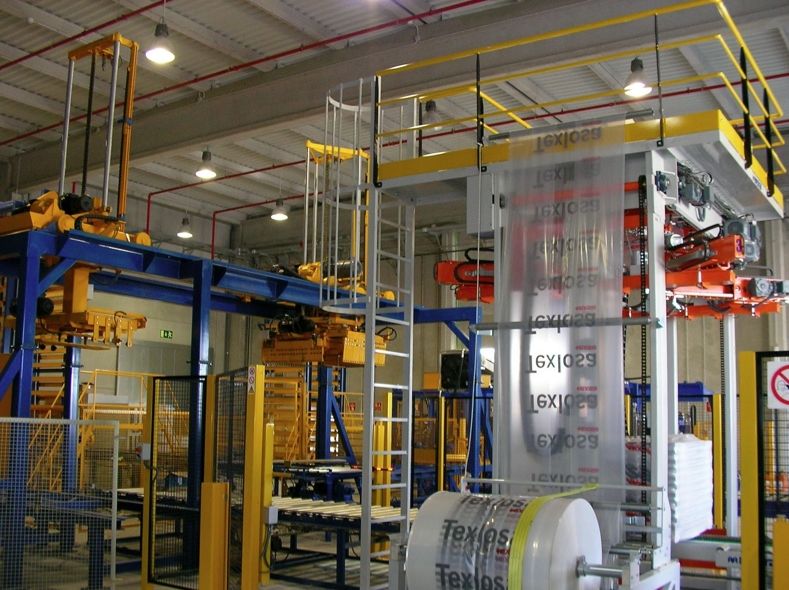 Strapping system for concrete block making machines
